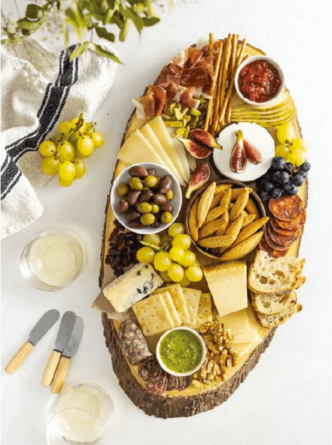 Tabla de aperitivo compuesta por quesos, frutas, olivas y dips condimentados con aceite de oliva O-Live & Co.